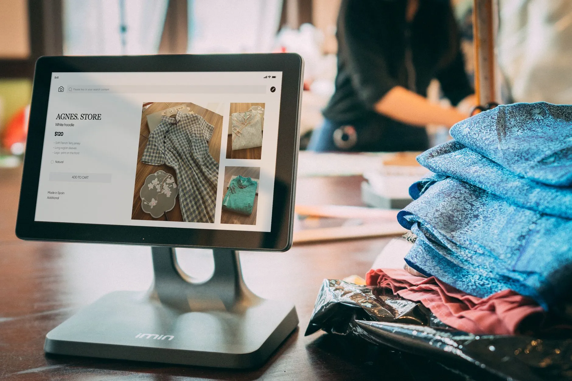Tablet point-of-sale system on the counter of a small clothing boutique