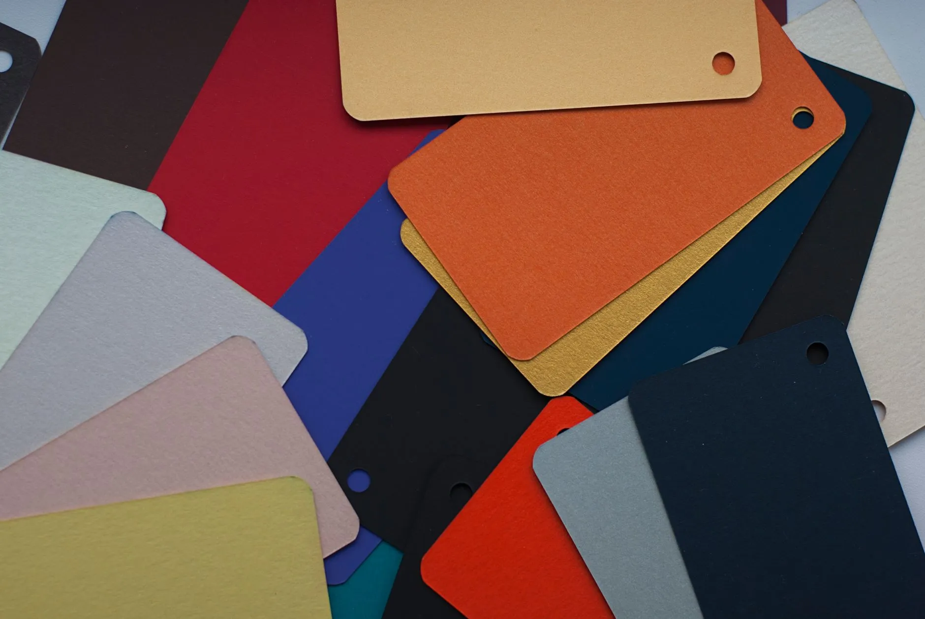Colorful cardboard swatches laid out from above to test a brand identity color palette