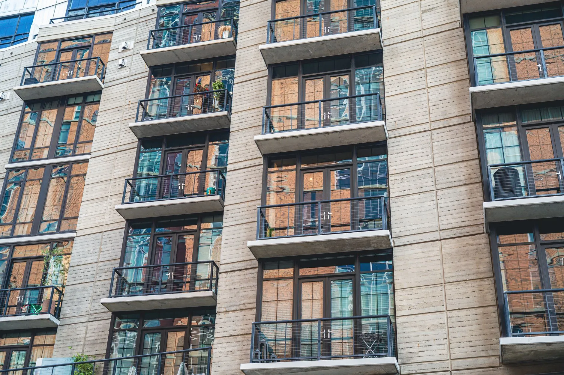 Modern apartment building with a concrete facade and glass balconies