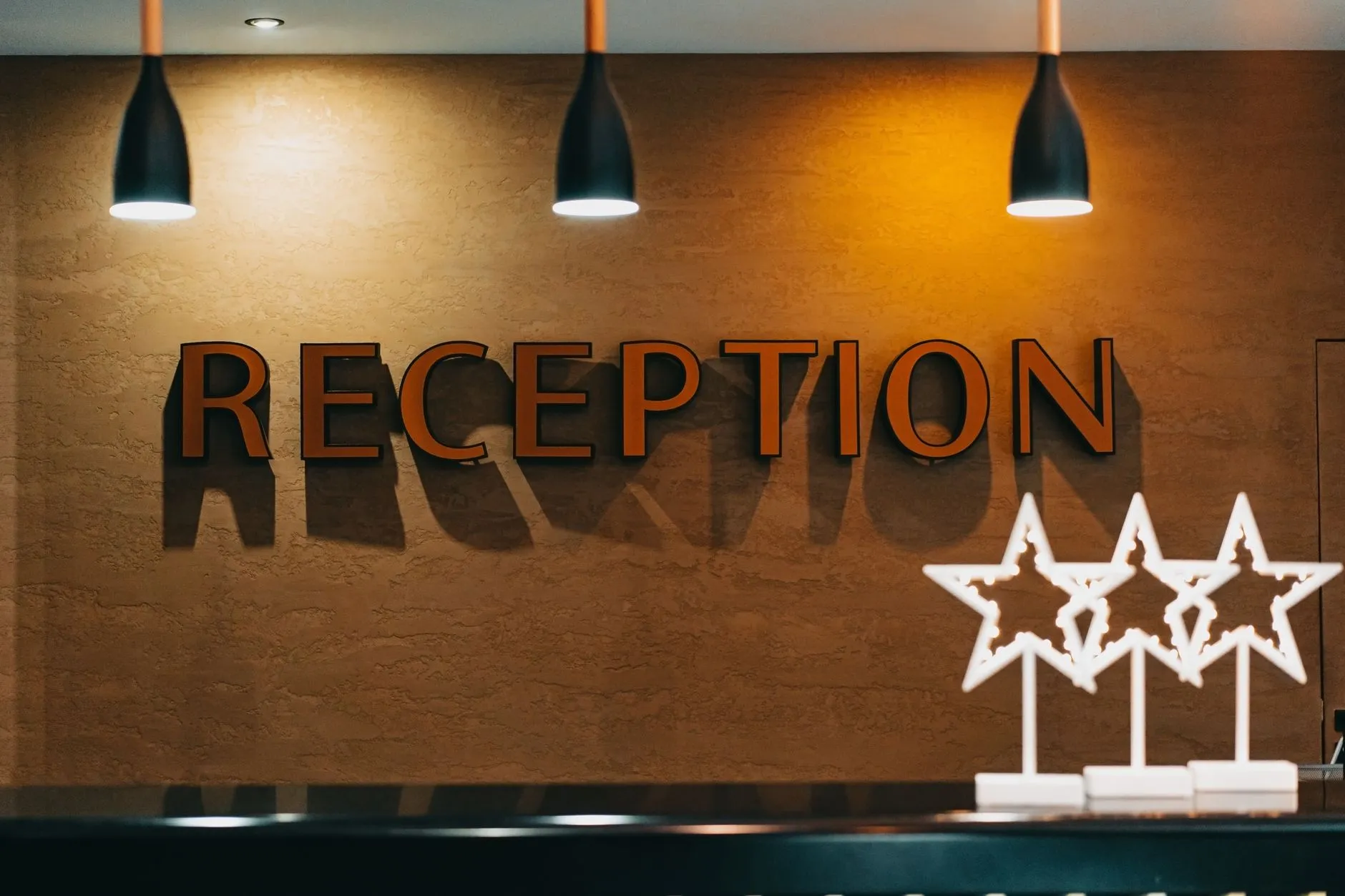 Hotel reception desk with warm lighting and signage